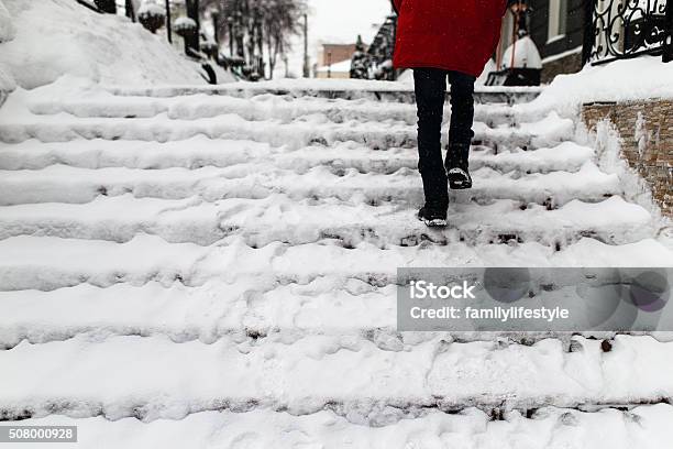 Woman Climbs The Stairs Stock Photo - Download Image Now - Sidewalk, Ice, Cold Temperature