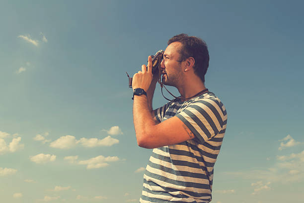 istock Young hipster man photographing with vintage camera. 508002206