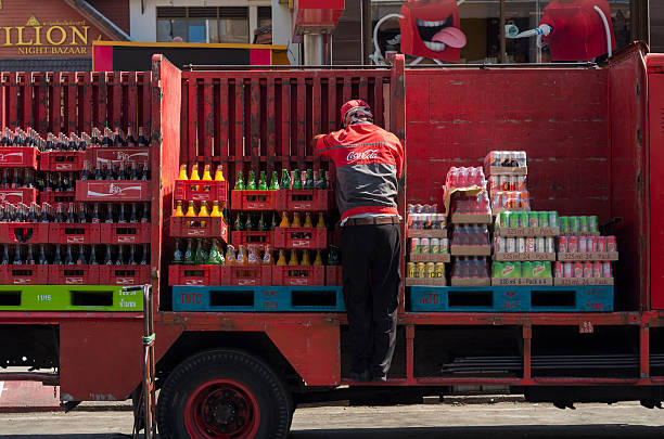 Chiang Mai, Thailand - January 23, 2016: Man loading soda bottles from transport truck.