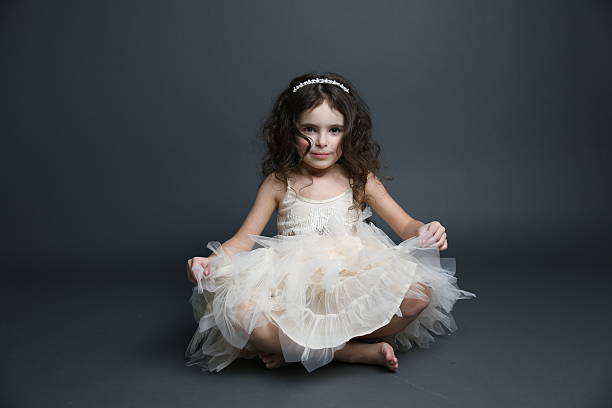 little girl playing dress up in tutu and tiara