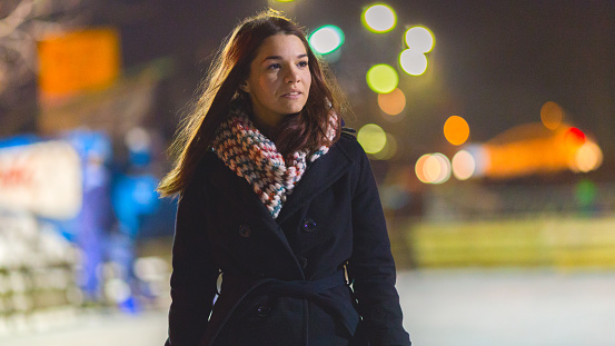 Shot of a beautiful young woman skating on an ice rink at night
