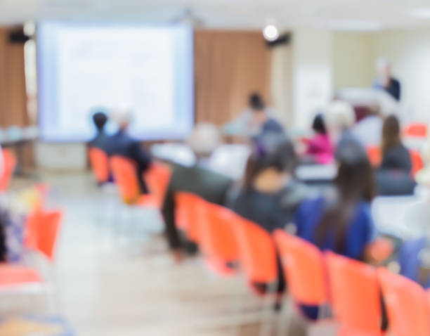 istock Blur audience sitting in conference room with screen 508005732