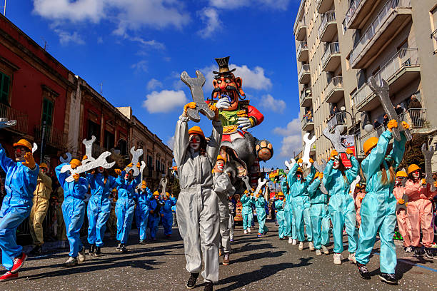 Carnival Putignano: allegorical float of Ilva industry. ITALY(Apulia) Putignano,Apulia,Italy - February 15, 2015: carnival floats, giant paper mache. Allegorical float of Ilva industry. painted masquerade masks stock pictures, royalty-free photos & images