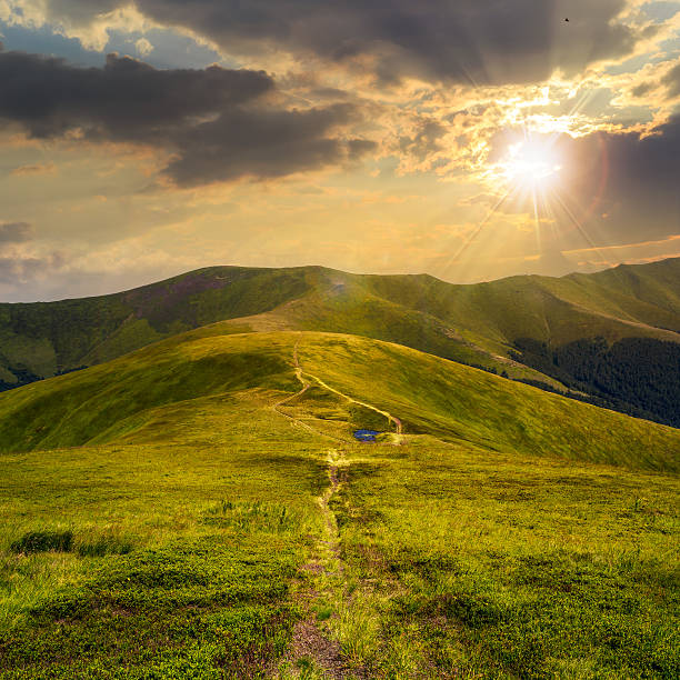 istock small lake on a Green Hill at sunset 508008933