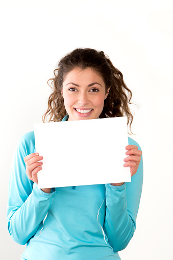 attractive young woman holding a blank A4 sign