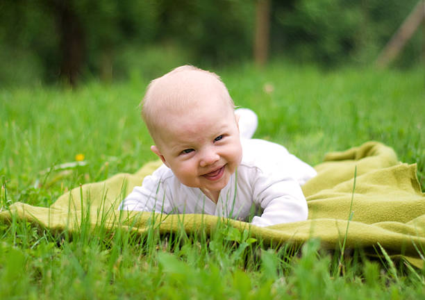 istock Happy baby lying on the grass 508009522