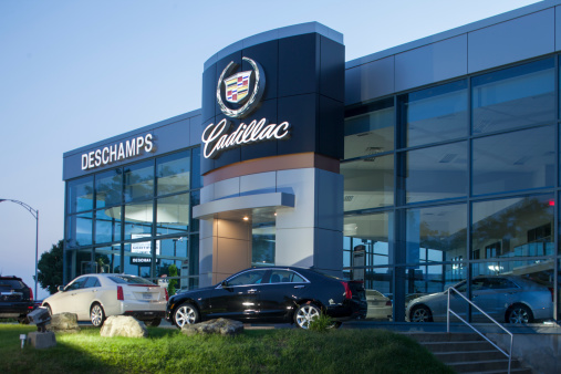 St-Julie,Quebec, Сanada - August 10, 2014: view of cars parked in front of a Cadillac dealership in st-julie at dusk