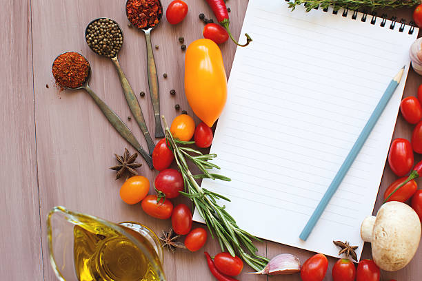 istock Notepads recipes on a wooden table. Fresh vegetables. 508012776
