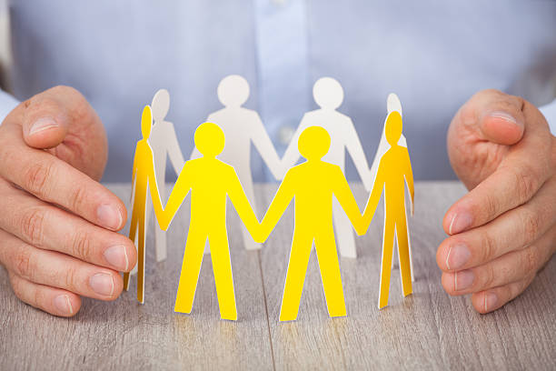 istock Hands Protecting Team Of Paper People 508012895