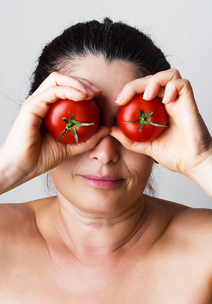 istock Asian woman showing tomatoes 508013565