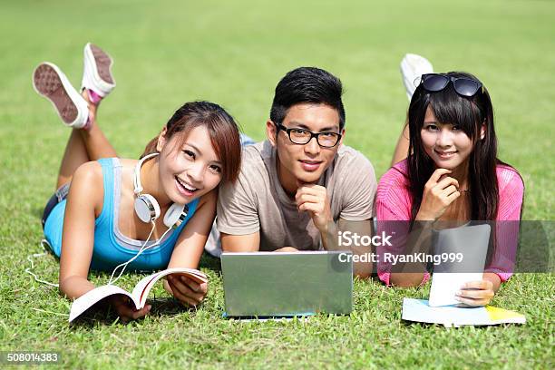 Happy College Students Using Computer Stock Photo - Download Image Now - Adult, Business, Business Person