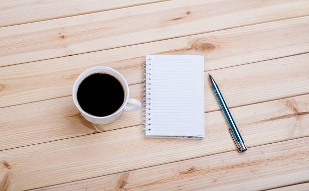 istock Blank Spiral Note Pad, Cup and Pen on Wood 508025182