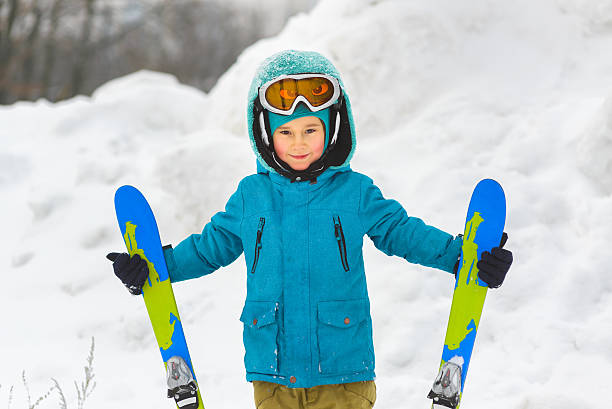 istock Boy in a blue jacket on skiing outdoor winter 508025734