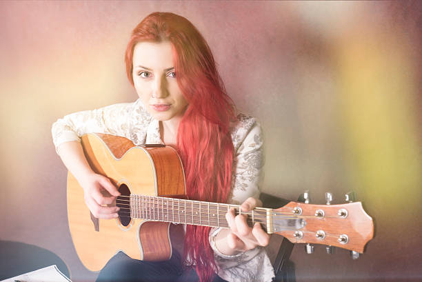 istock Red-haired girl playing guitar 508026166
