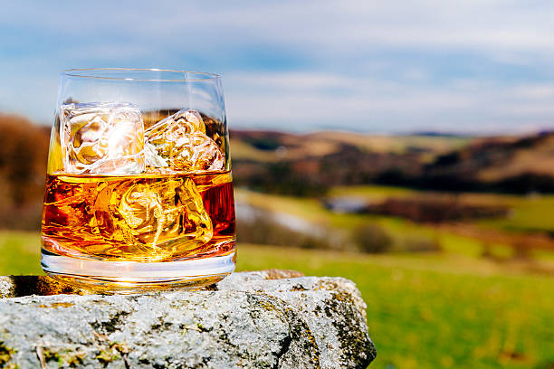 Scotland is Whisky country Glass of whisky on the rocks, literally and metaphorically, outdoors in the Scottish Highlands AdobeRGB colorspace. scotch whisky stock pictures, royalty-free photos & images