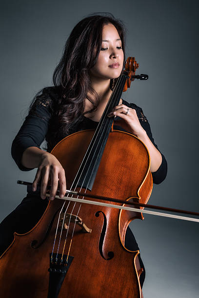 Female Cellist Playing Cello stock photo