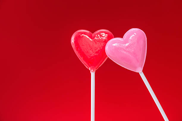 istock Lean on me, heart shaped lollipops against a red background 508030198