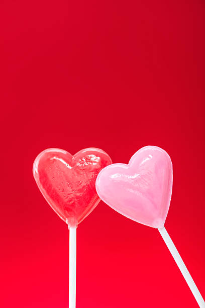 istock Lean on me, heart shaped lollipops against a red background 508031328