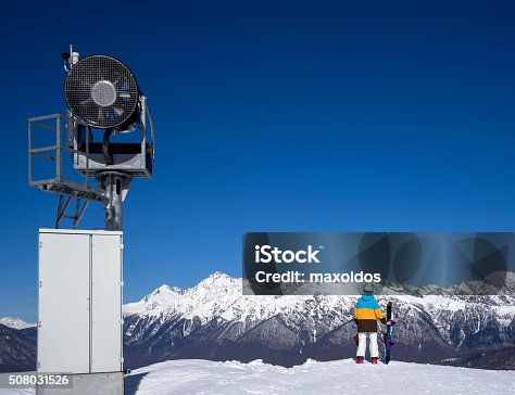 istock Snow Gun and snowboarder woman in mountains 508031526