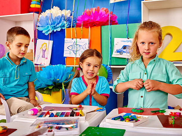 istock Group kids mold from plasticine  in kindergarten 508035298