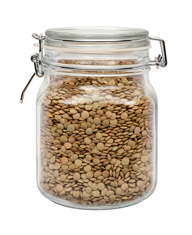 Lentils in a Glass Canister with a Metal Clamp. The image is a cut out, isolated on a white background, with a clipping path.