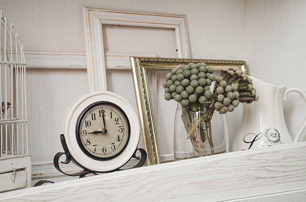 istock Retro mechanical clock on shelf and decor flowers 508036740