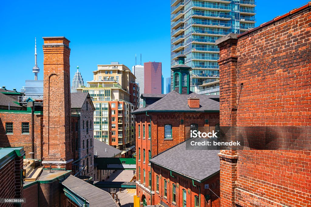 Toronto Canada Distillery District Photo of old brick towers of the chic Distillery District with new condos and downtown skyscrapers in the background in Toronto, Ontario, Canada. Toronto Stock Photo