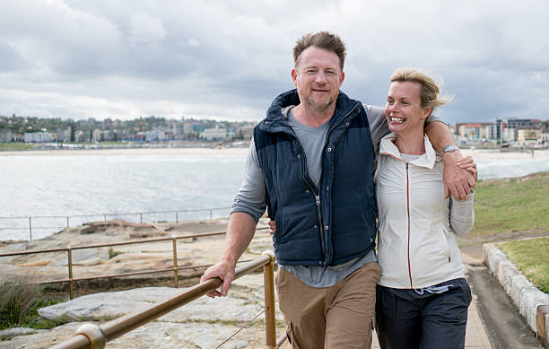 istock Australian couple walking by the beach 508039802