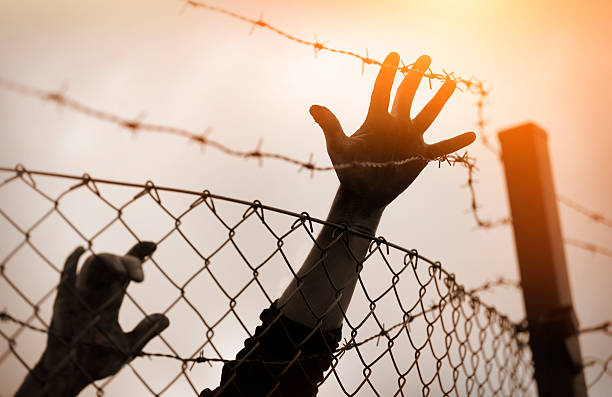 istock Refugee men and fence. Refugee concept 508039986