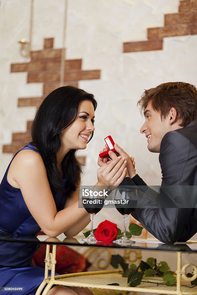 marriage proposal, man give ring to his girl marriage proposal, man give ring to his girl, young happy couple romantic date at restaurant, celebrating valentine day 20-24 Years Stock Photo