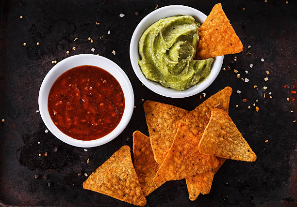 Mexican food concept â Doritos, guacamole and salsa stock photo