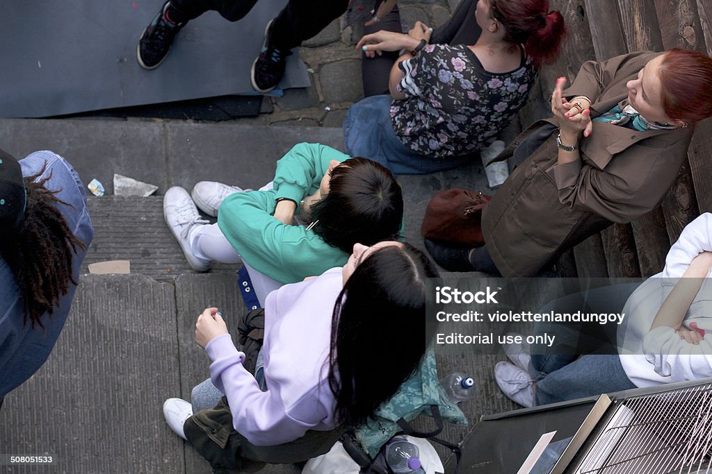 People watching Dancers London, UK - July 11, 2014: Colour photograph of young people gathered to watch a dance crew perform in Camden Market, one lady with red hair dressed in a brown trench coat is clapping. Camden Town, also called Camden Lock. The Market is one of the most popular attraction in London attracting about 100,000 visitors each Activity Stock Photo