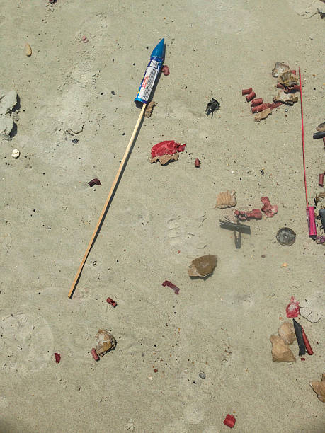 Discarded fireworks on the sand stock photo