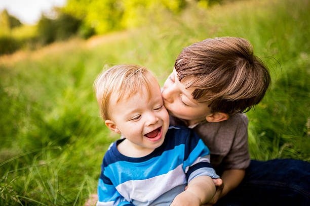 istock Brother kissing sibling on Cheek 508052631