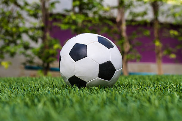 istock Football on the green grass 508053062