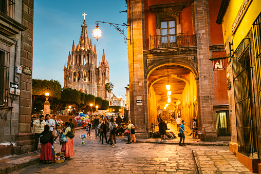 San Miguel de Allende, Mexico - February 1, 2016: Two woman wearing traditional Mexican clothes sell souvenirs to the passersby in the town center.