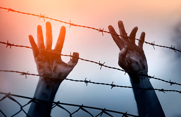 istock Refugee men and fence 508054066