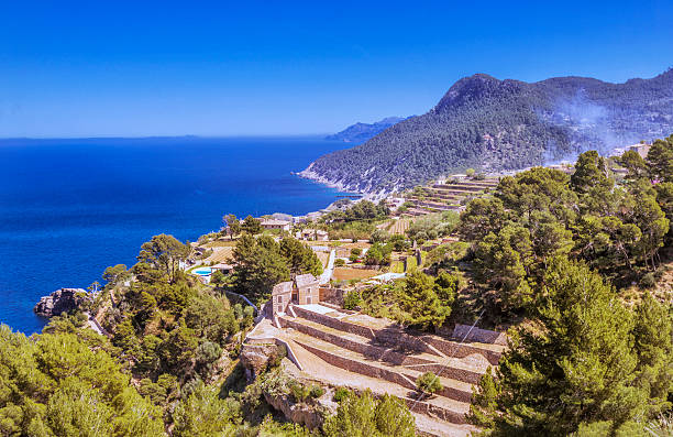 Coastline at Banyalbufar in the Tramuntana mountains, Mallorca Banyalbufar a seaside village located on the north coast of Mallorca at the Tramuntana´s mountains, and famous for the "marjades" (stepped slopes), agriculture and winery. banyalbufar stock pictures, royalty-free photos & images