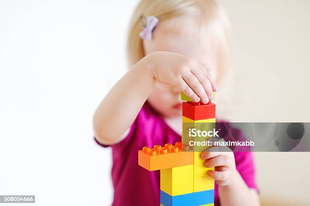 Cute Toddler Girl Playing With Colorful Blocks Stock Photo - Download Image Now - 12-17 Months, Activity, Babies Only