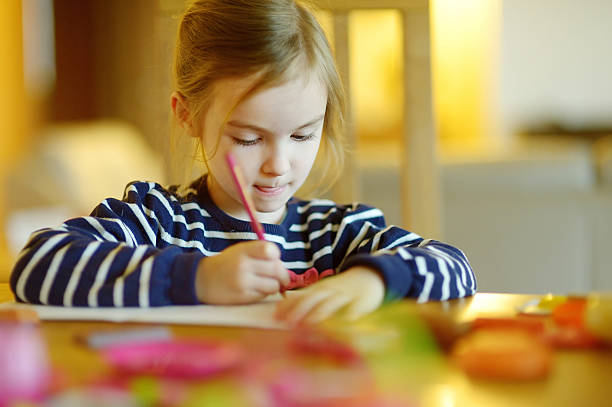 istock Cute little girl is drawing with pencils 508055730