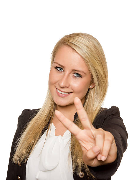 Young woman showing peace sign with her hands stock photo
