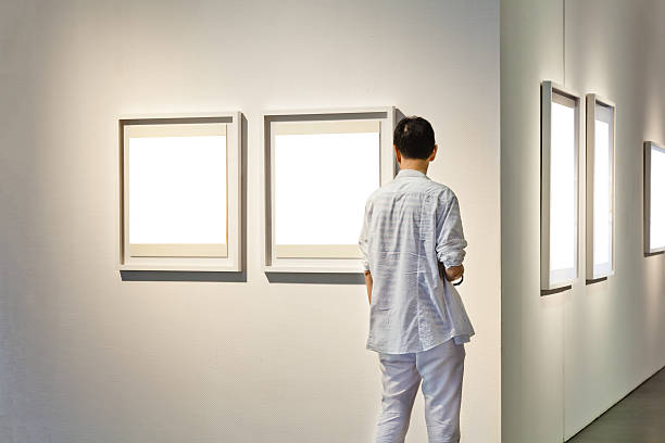 istock One man looking at white frames in an art gallery 508059744