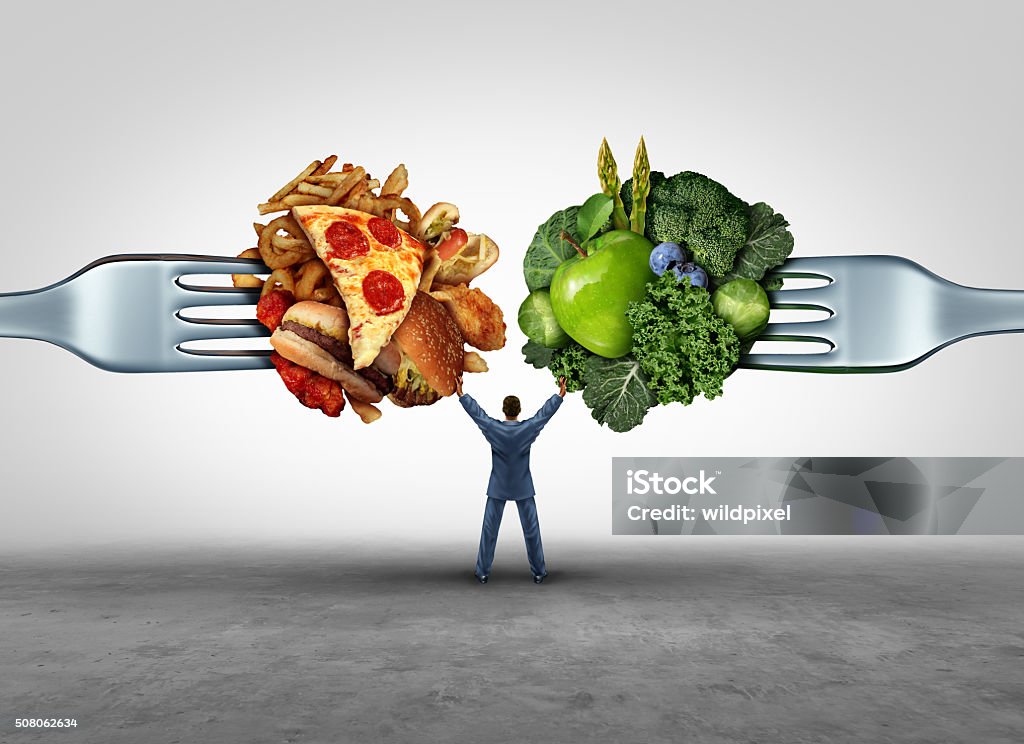 Food Health Decision Food health decision and diet choice concept and nutrition options dilemma between healthy good fresh fruit and vegetables or greasy cholesterol rich fast food on a fork with a man in the middle uncertain of what to eat. Food Stock Photo