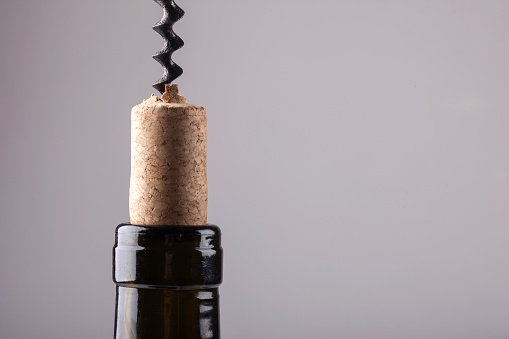 neck of a wine bottle cork and corkscrew closeup