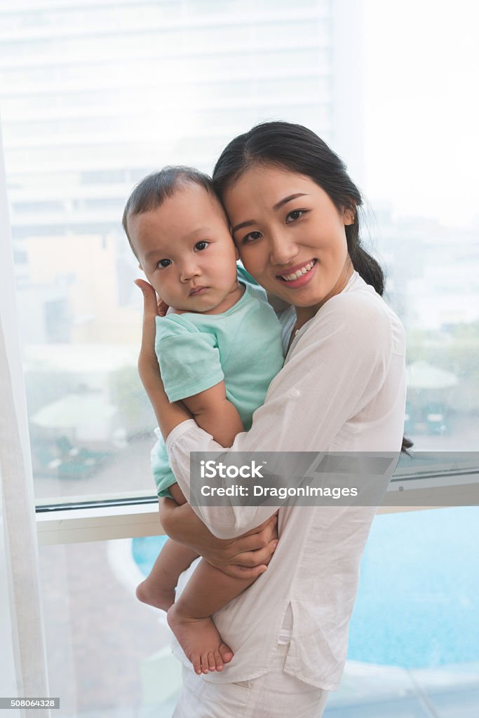 Woman and her baby Beautiful young woman holding her baby boy Adult Stock Photo