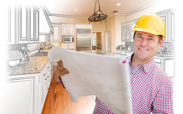 istock Contractor Holding Blueprints Over Custom Kitchen Drawing and Photo 508064336