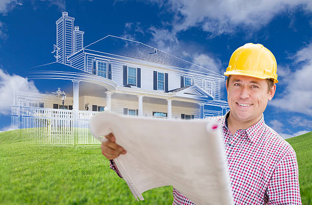 istock Contractor Holding Blueprints Over Custom Home Drawing and Photo 508065054
