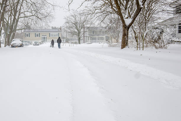 istock two people walking down a country road in blizzard storm 508066496
