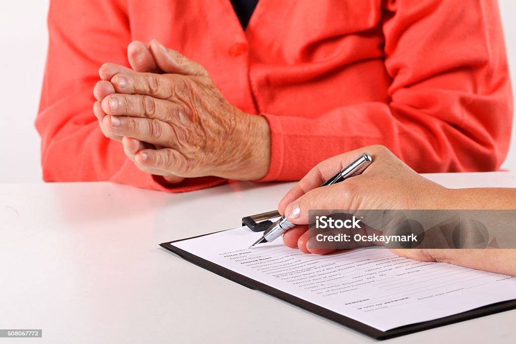 Medical record Female doctor's hand filling the medical record Document Stock Photo