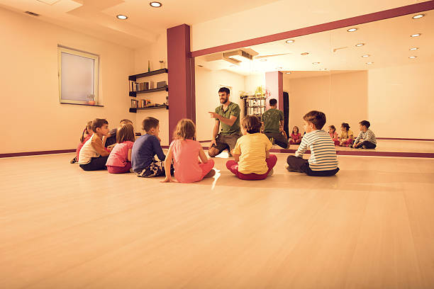 istock Happy coach talking to children before sports training. 508069556